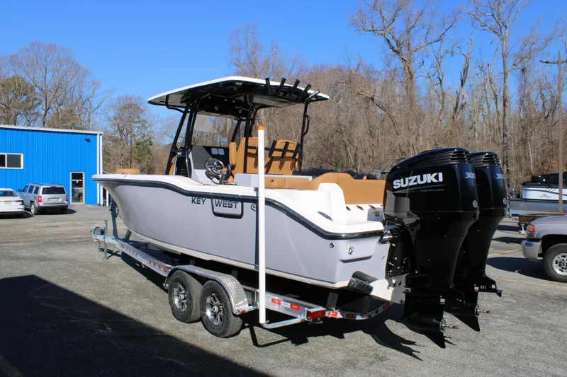 Slide: The Image of 2025 Key West 263 FS boat on trailer, side view, outdoors. - 5