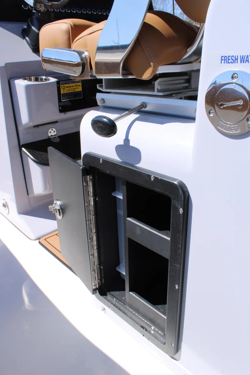 Slide: The Image of 2025 Key West 263 FS boat with Suzuki outboard motor, parked outdoors. - 8