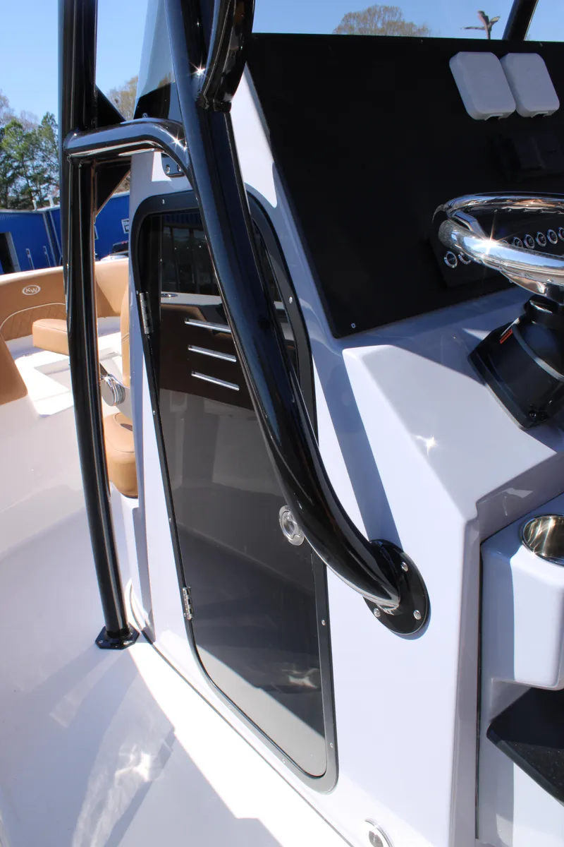 Slide: The Image of 2025 Key West 263 FS boat dashboard with steering wheel and controls. - 9