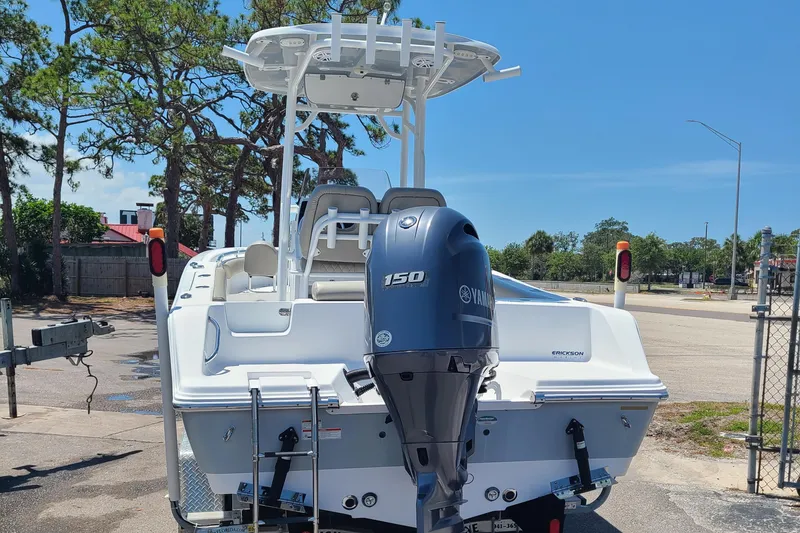 Slide: The Image of 2021 Sportsman Open 212 Center Console boat with Yamaha 150 engine, parked outdoors. - 2