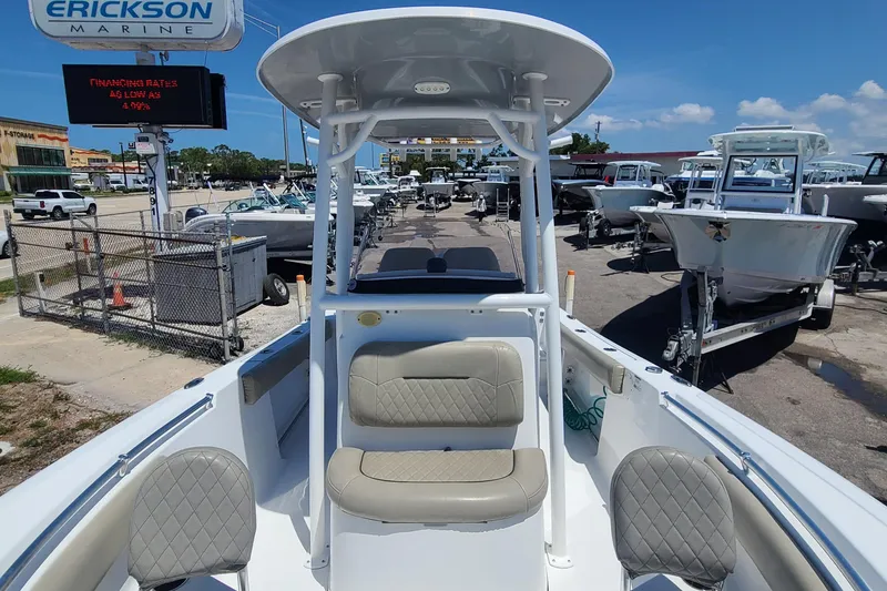 Slide: The Image of 2021 Sportsman Open 212 Center Console boat at dealership, featuring seating and console. - 9