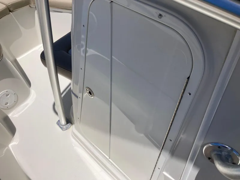 Slide: The Image of White door on 2012 Sailfish 2180 boat deck, featuring sleek design and stainless steel hardware. - 13