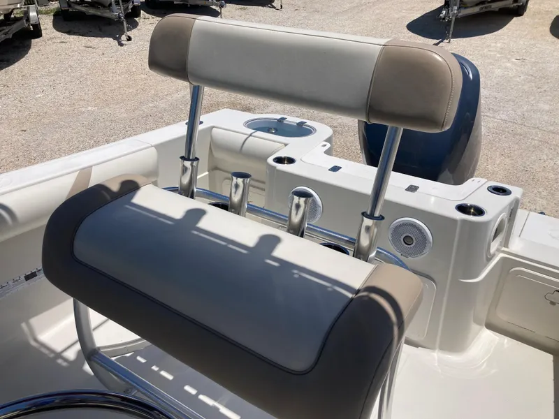 Slide: The Image of 2012 Sailfish 2180 boat interior with cushioned seating and rod holders. - 15