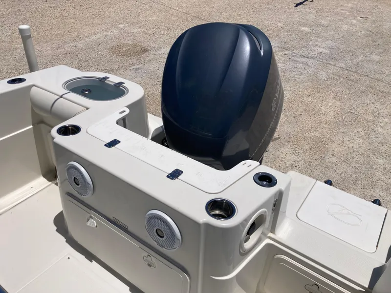 Slide: The Image of 2012 Sailfish 2180 boat with outboard motor and built-in speakers. - 16