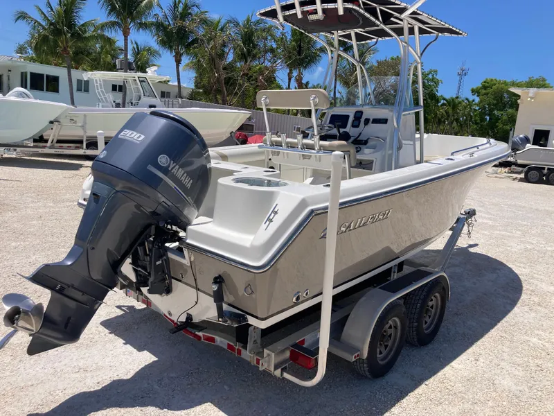 Slide: The Image of 2012 Sailfish 2180 boat on trailer with Yamaha outboard motor, parked outdoors. - 3