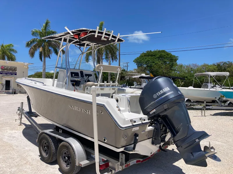 Slide: The Image of 2012 Sailfish 2180 boat on trailer with Yamaha outboard motor, parked outdoors. - 4