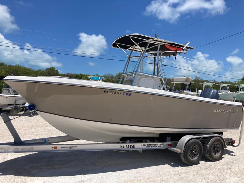 Slide: The Image of 2012 Sailfish 2180 boat on trailer under clear blue sky. - 5