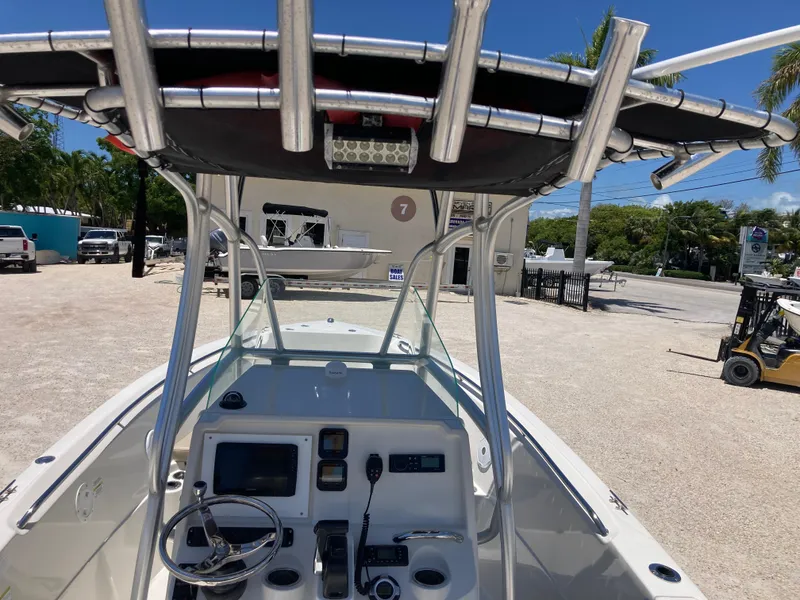 Slide: The Image of 2012 Sailfish 2180 boat cockpit with steering wheel and controls, parked outdoors. - 7