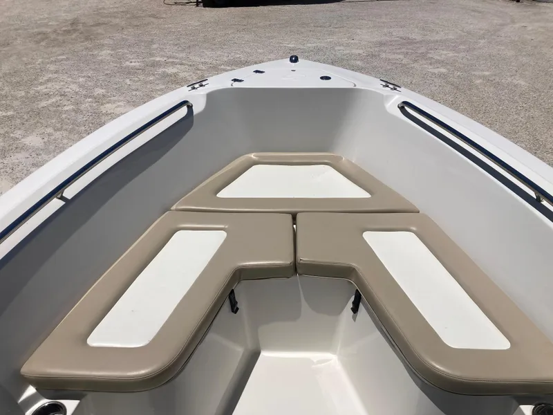 Slide: The Image of 2012 Sailfish 2180 boat interior with beige seating and white accents. - 8