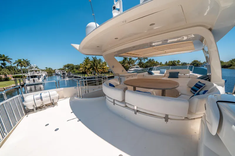 Slide: The Image of Luxurious 2010 Azimut 75 Fly yacht deck with seating, table, and scenic waterfront view. - 11
