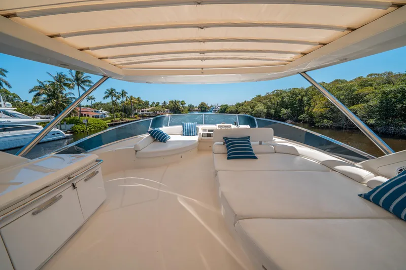 Slide: The Image of Luxurious 2010 Azimut 75 Fly yacht deck with plush seating and scenic waterfront view. - 14