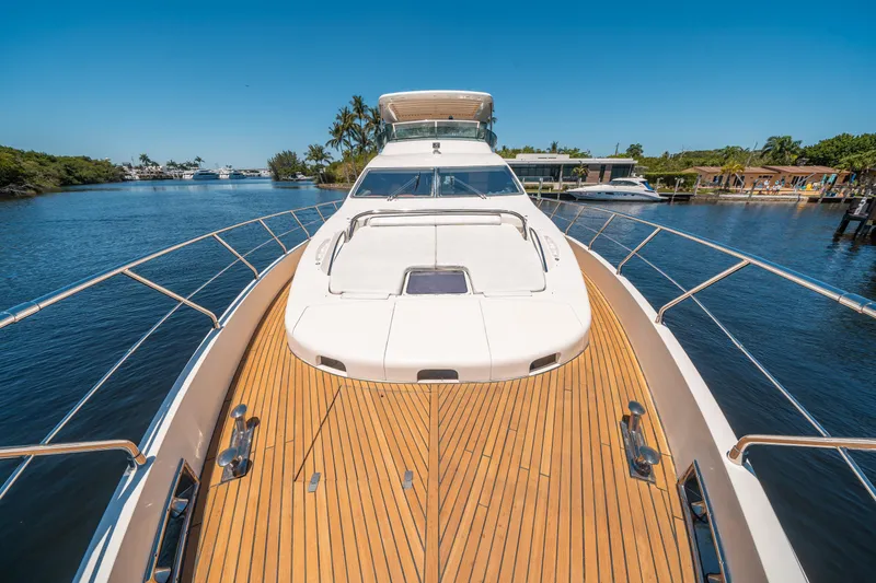 Slide: The Image of 2010 Azimut 75 Fly yacht on serene waterway, showcasing sleek design and spacious deck. - 19