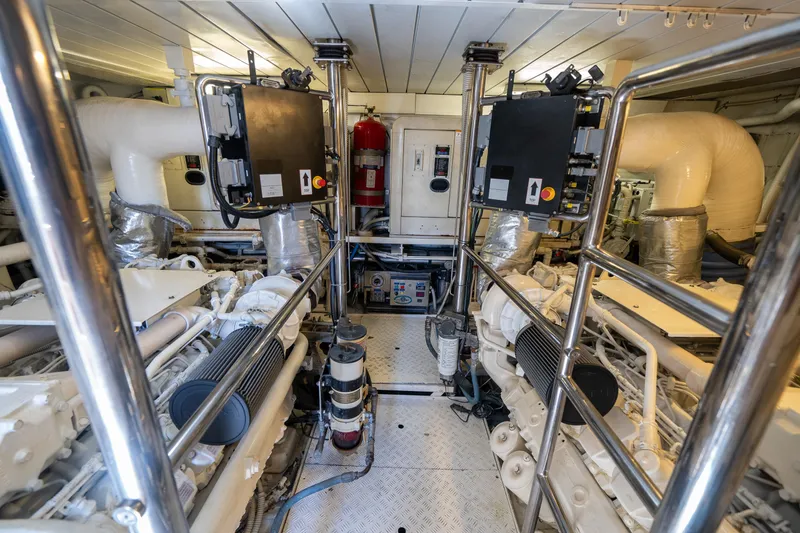Slide: The Image of Engine room of a 2010 Azimut 75 Fly yacht, featuring dual engines and safety equipment. - 45