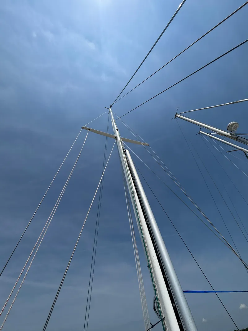 Slide: The Image of Mast and rigging of 1995 Pacific Seacraft Crealock 37 sailboat against a cloudy sky. - 10