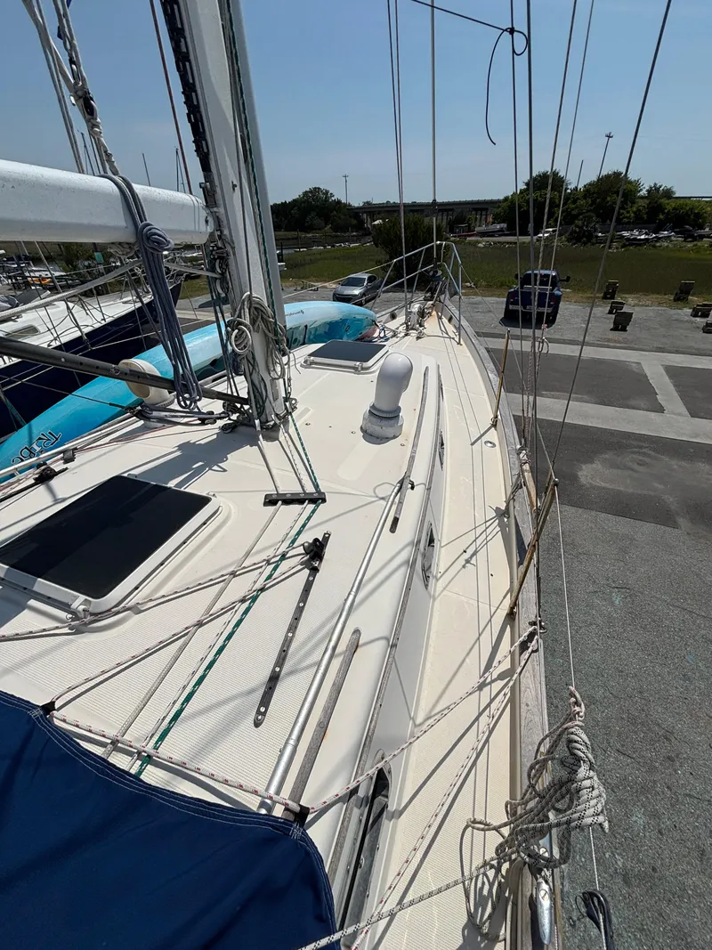 Slide: The Image of 1995 Pacific Seacraft Crealock 37 sailboat deck with rigging and marina view. - 11
