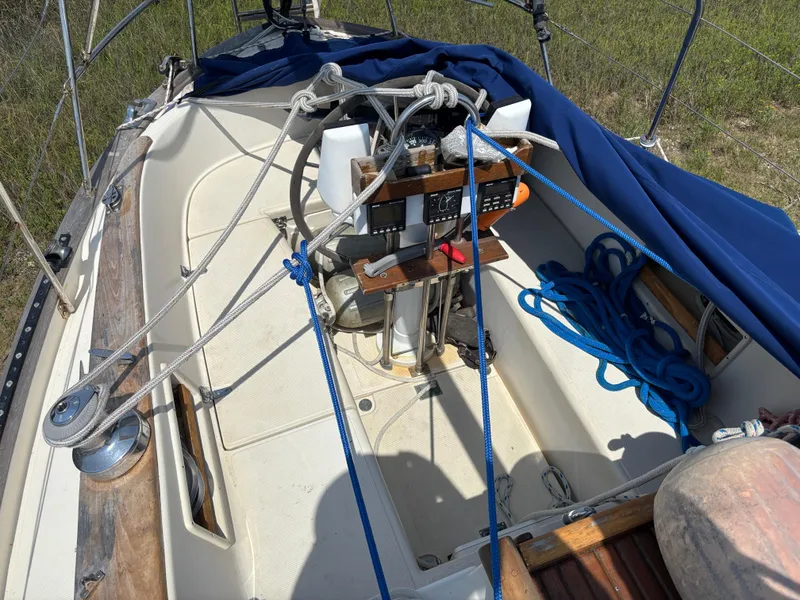 Slide: The Image of Cockpit of 1995 Pacific Seacraft Crealock 37 sailboat with ropes and navigation equipment. - 12