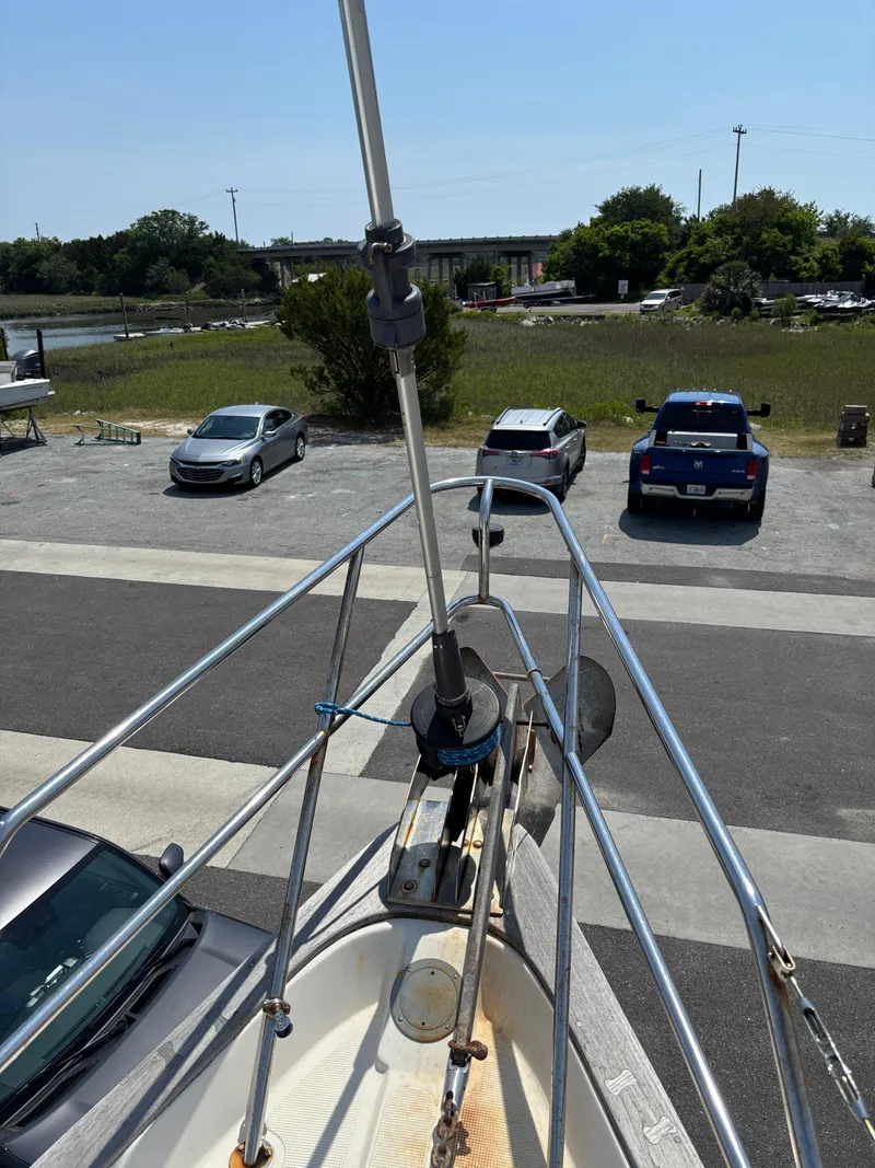 Slide: The Image of Pacific Seacraft Crealock 37 sailboat bow, 1995 model, parked near a road and grassy area. - 15