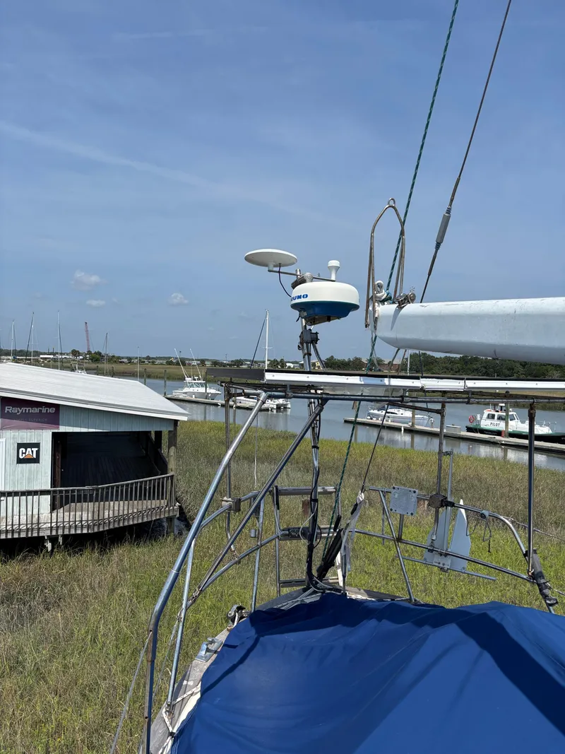 Slide: The Image of Pacific Seacraft Crealock 37 sailboat, 1995 model, docked near a marina with clear skies. - 16