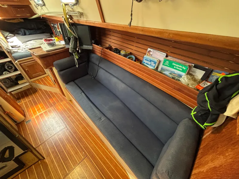 Slide: The Image of Cozy interior of 1995 Pacific Seacraft Crealock 37 sailboat with wooden flooring and blue seating. - 24