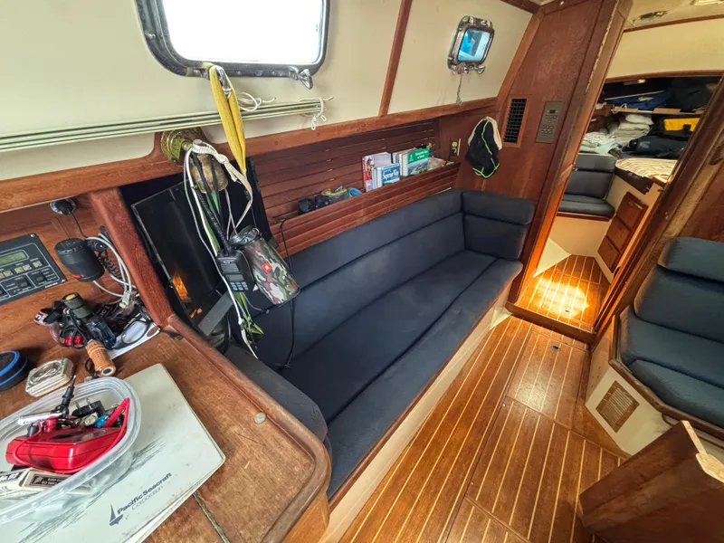 Slide: The Image of Interior of 1995 Pacific Seacraft Crealock 37 sailboat with wooden flooring and navy seating. - 25