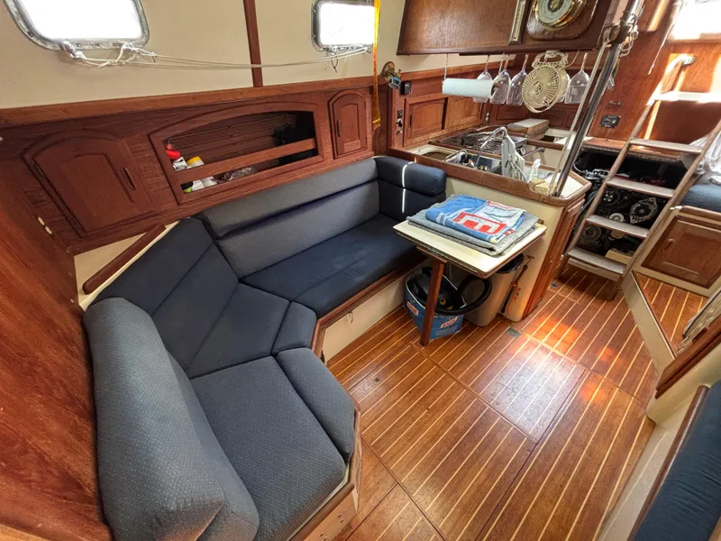 Slide: The Image of Interior of 1995 Pacific Seacraft Crealock 37 sailboat with cozy seating and wooden flooring. - 26