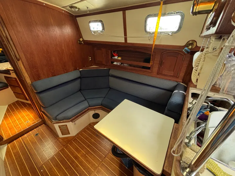Slide: The Image of Interior of 1995 Pacific Seacraft Crealock 37 sailboat with cozy seating and wooden finishes. - 27