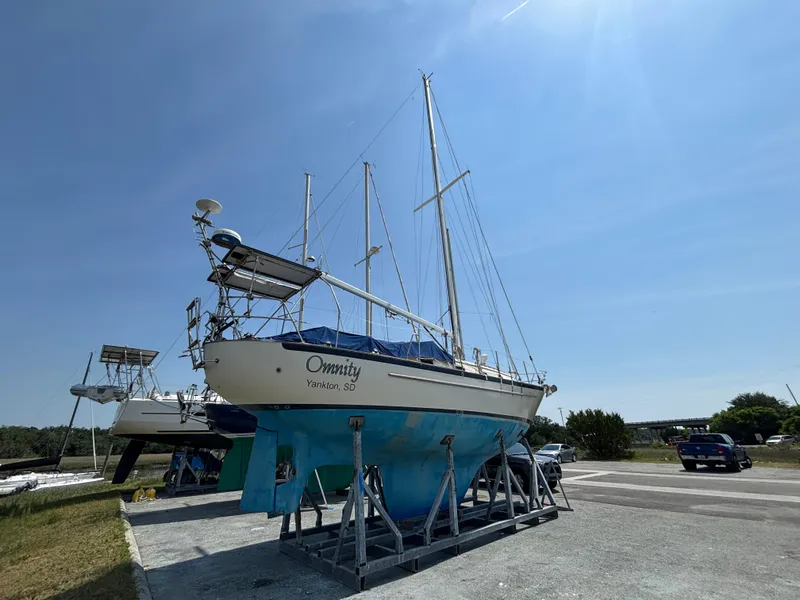 Slide: The Image of 1995 Pacific Seacraft Crealock 37 sailboat on stands under clear blue sky. - 3