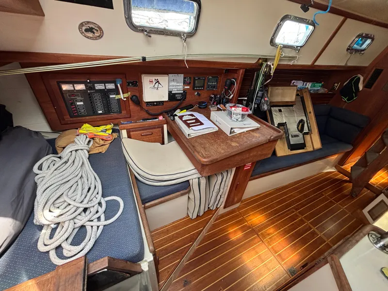 Slide: The Image of Interior of 1995 Pacific Seacraft Crealock 37 sailboat with navigation station and seating area. - 30
