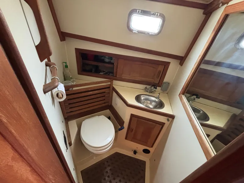 Slide: The Image of Bathroom interior of 1995 Pacific Seacraft Crealock 37 sailboat, featuring sink and toilet. - 33