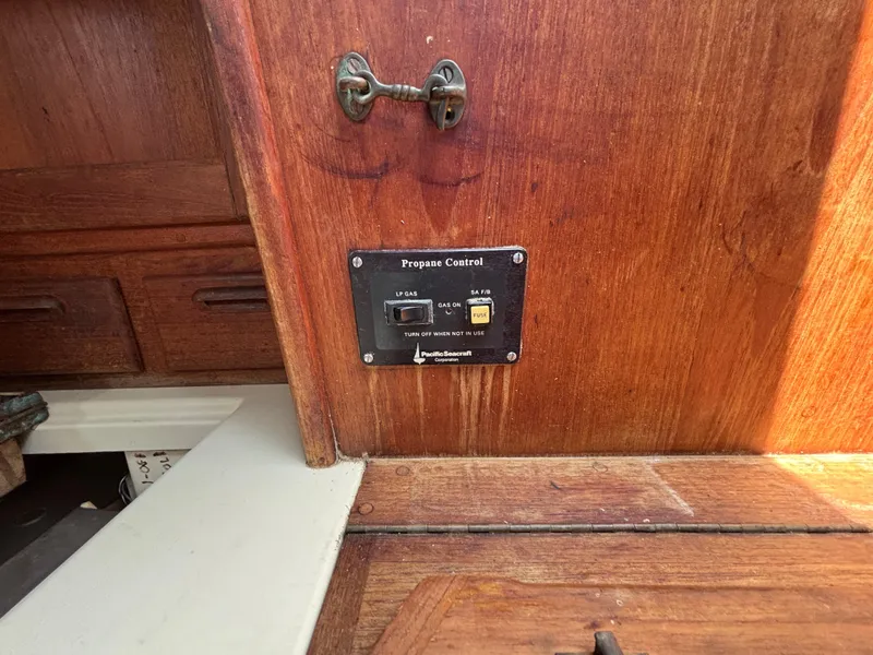 Slide: The Image of Propane control panel on 1995 Pacific Seacraft Crealock 37 sailboat interior wood paneling. - 36