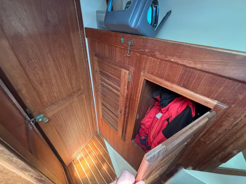 Slide: The Image of Interior of 1995 Pacific Seacraft Crealock 37 with wooden cabinetry and storage compartment. - 37
