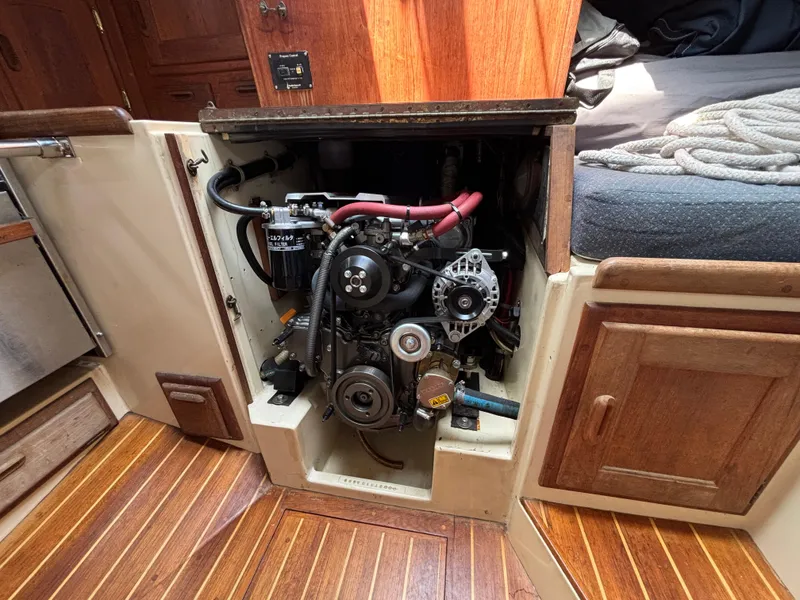 Slide: The Image of Engine compartment of a 1995 Pacific Seacraft Crealock 37 sailboat, featuring wooden cabinetry. - 39