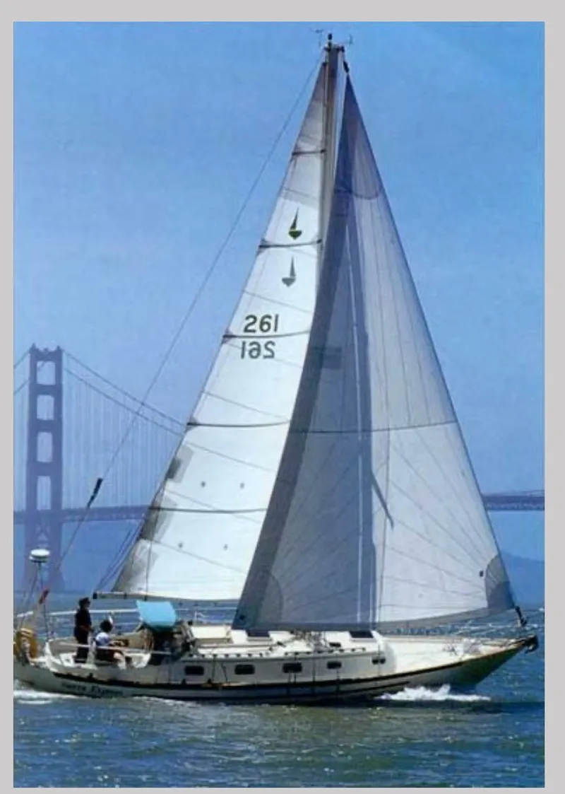 Slide: The Image of Sailboat Pacific Seacraft Crealock 37, 1995 model, sailing near a bridge on a sunny day. - 42