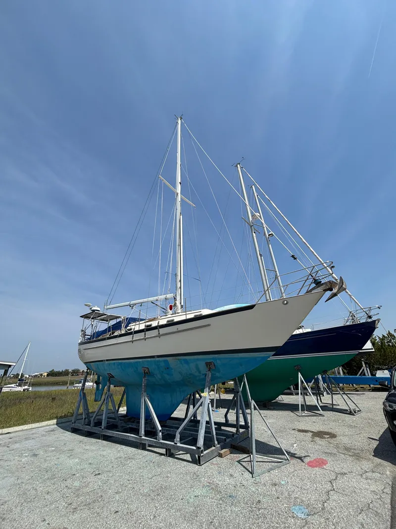 Slide: The Image of Sailboat on stands, Pacific Seacraft Crealock 37, 1995 model, under clear blue sky. - 5