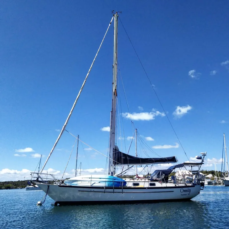 Slide: The Image of 1995 Pacific Seacraft Crealock 37 sailboat on calm water under clear blue sky. - 8