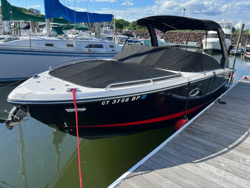 The Image of 2023 Chaparral 287 SSX boat docked in marina, covered and ready for use. - 0