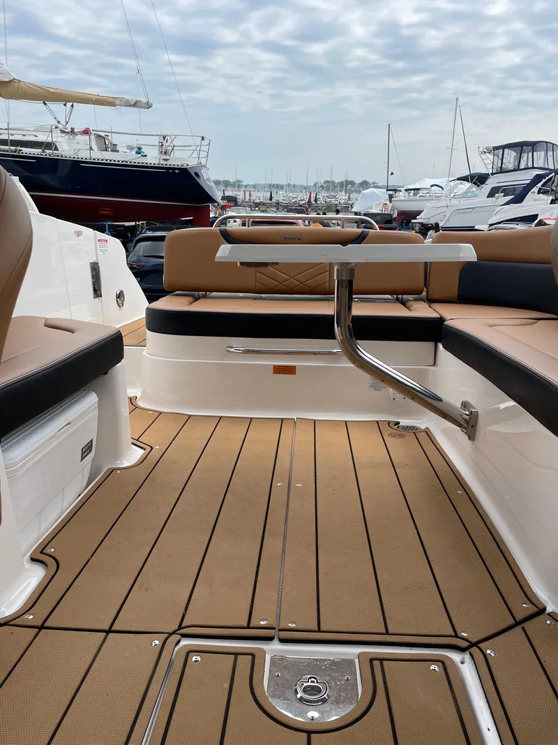 Slide: The Image of 2023 Chaparral 287 SSX boat interior with tan leather seating and sleek dashboard design. - 14