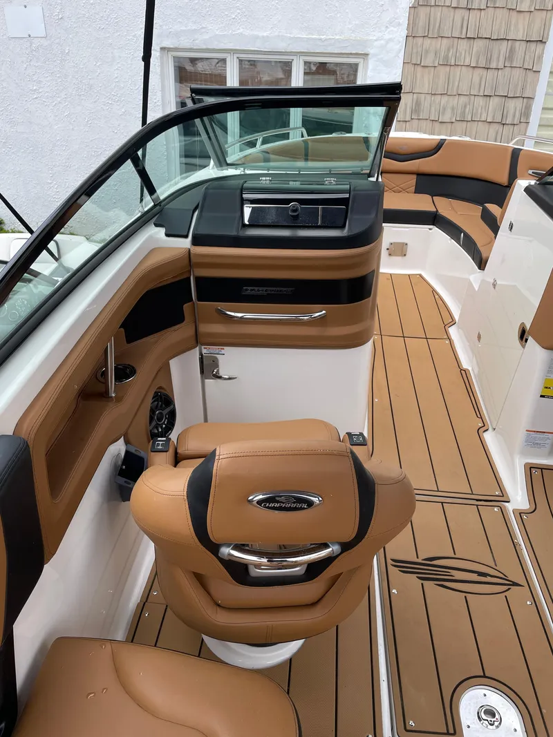 Slide: The Image of 2023 Chaparral 287 SSX boat interior with tan leather seats and modern dashboard. - 20