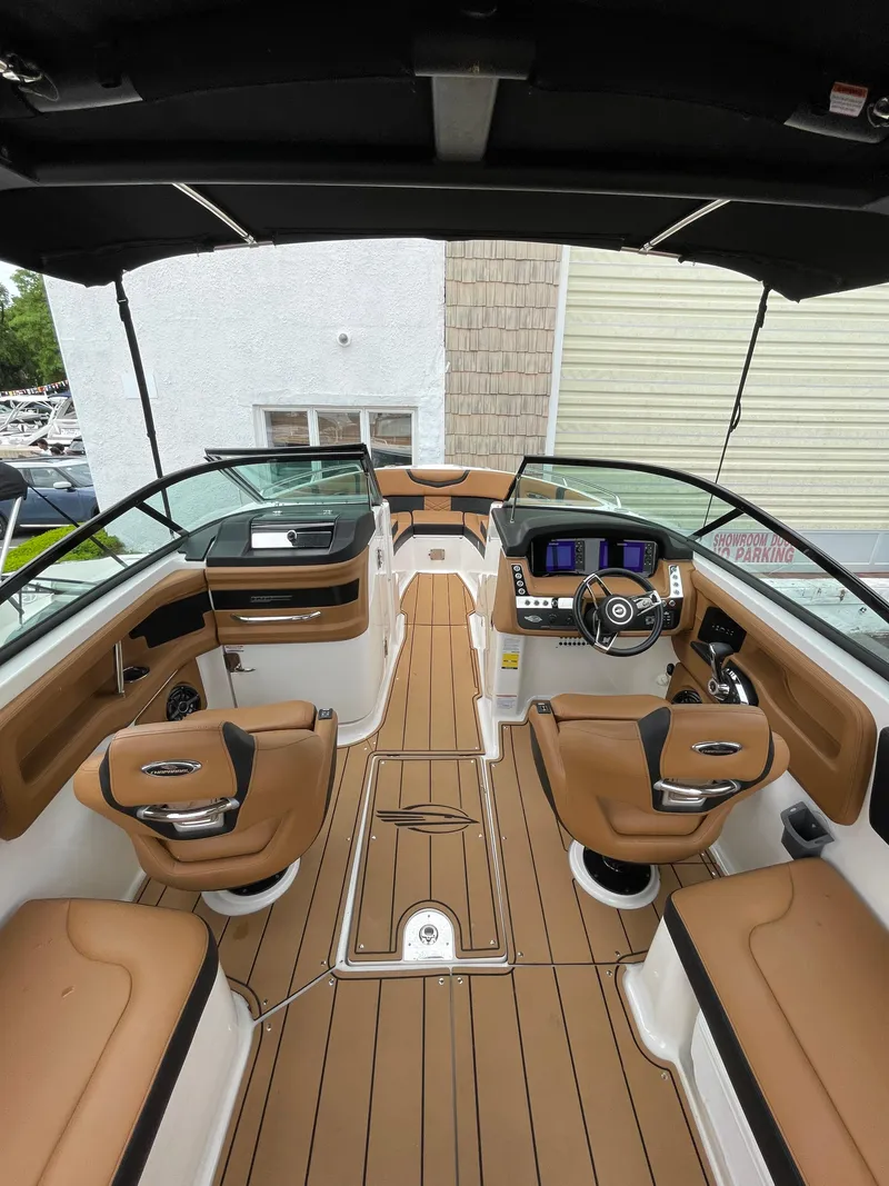Slide: The Image of 2023 Chaparral 287 SSX boat interior with luxurious seating and modern dashboard. - 22