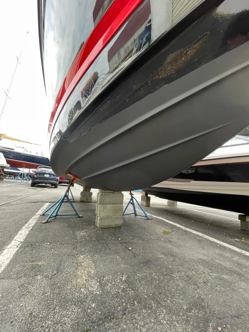 Slide: The Image of 2023 Chaparral 287 SSX boat on stands, showcasing sleek hull design. - 30