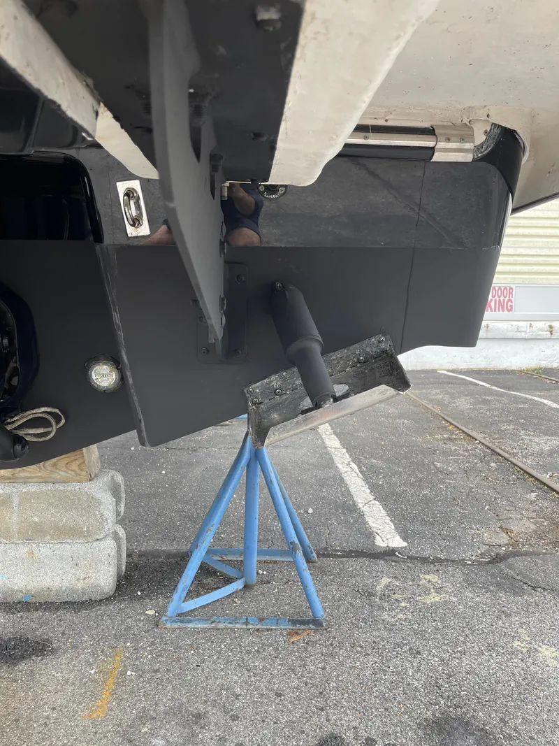 Slide: The Image of 2023 Chaparral 287 SSX boat on a stand, showing the hull and propeller area. - 32