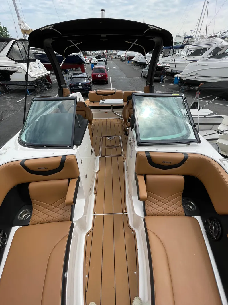 Slide: The Image of 2023 Chaparral 287 SSX boat interior with tan and black seating. - 7