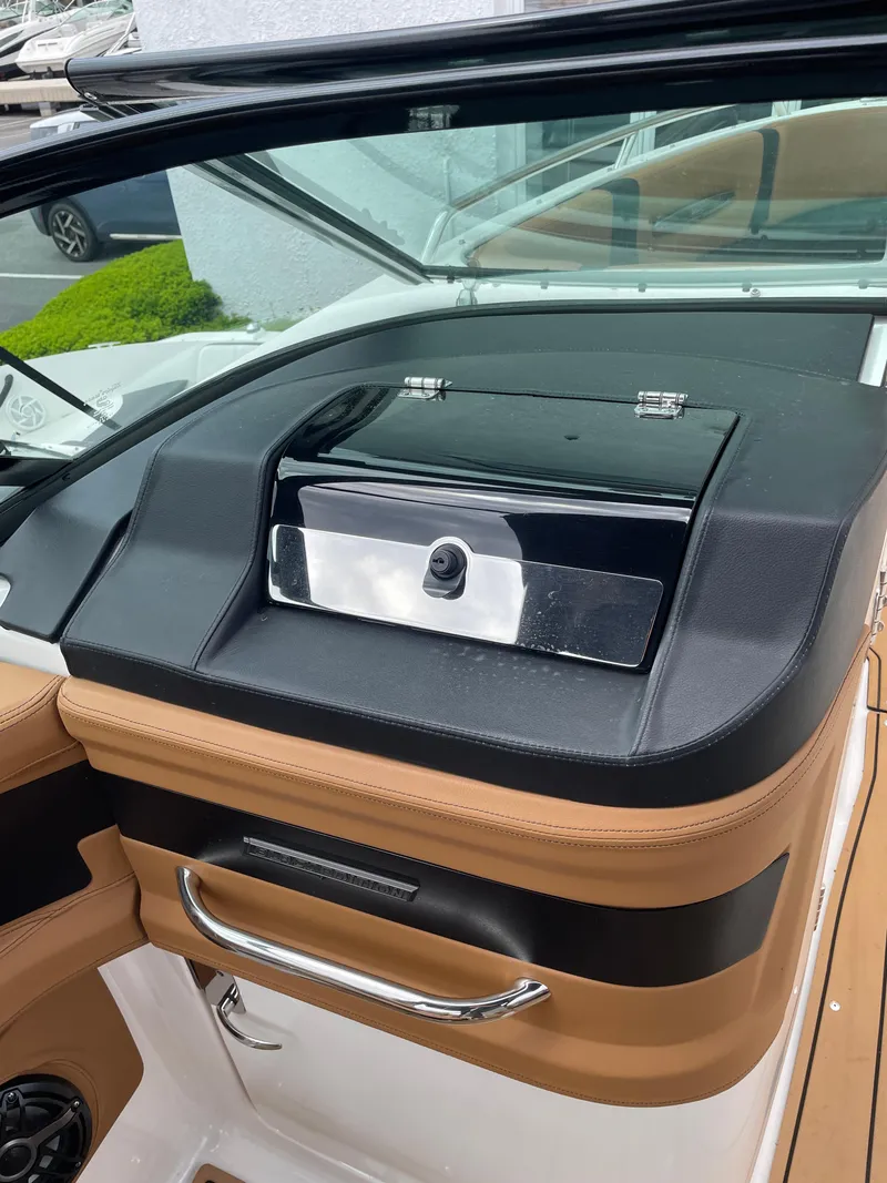Slide: The Image of 2023 Chaparral 287 SSX dashboard with sleek black and tan design. - 9
