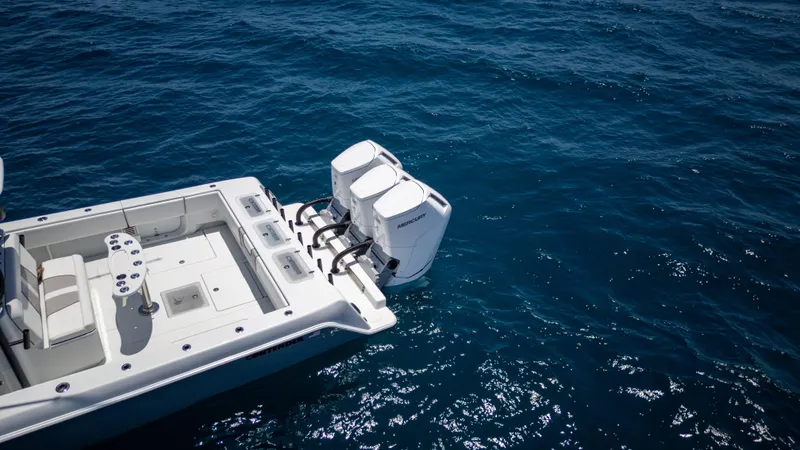 Slide: The Image of 2023 Contender 44 CB boat with dual outboard motors on open sea. - 10