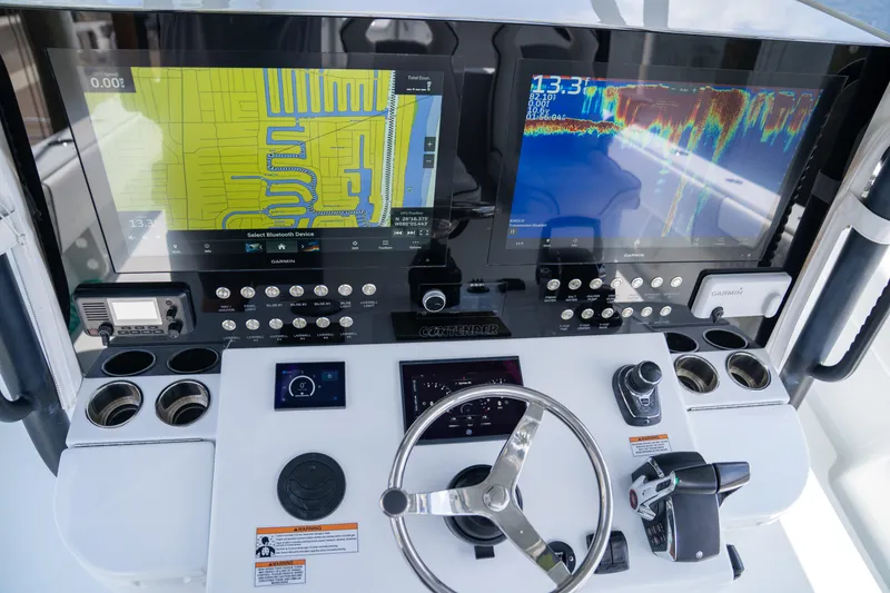 Slide: The Image of Control panel of 2023 Contender 44 CB boat with navigation and sonar displays. - 21