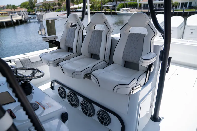 Slide: The Image of Luxury seating on 2023 Contender 44 CB boat, featuring three cushioned seats and modern design. - 22