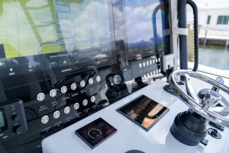 Slide: The Image of Control panel of 2023 Contender 44 CB boat with advanced navigation systems. - 23
