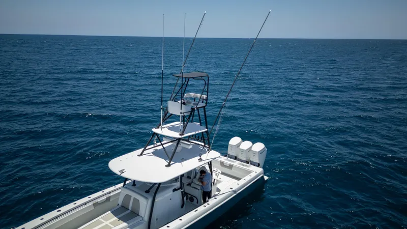 Slide: The Image of 2023 Contender 44 CB boat on open ocean, featuring multiple outboard engines. - 25