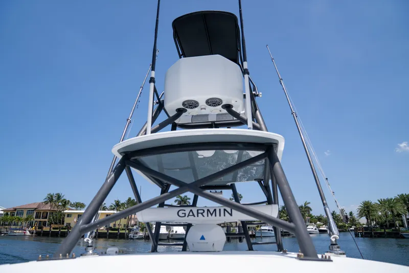 Slide: The Image of 2023 Contender 44 CB boat with Garmin equipment, viewed from below, against a clear blue sky. - 26