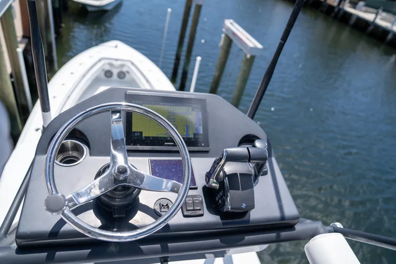 Slide: The Image of Helm of 2023 Contender 44 CB boat with steering wheel and navigation system. - 27